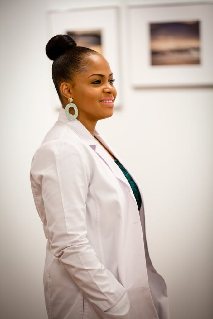 woman-in-white-medical-robe-3714743 Portrait of a smiling female doctor in a white coat, exuding professionalism and confidence.